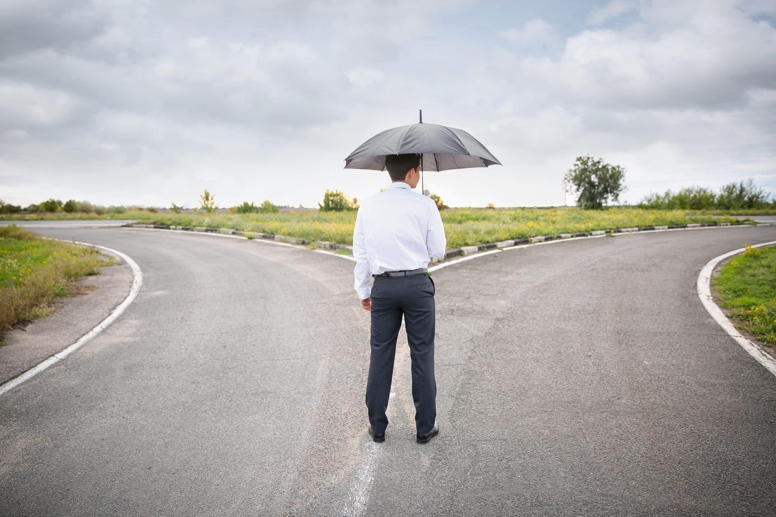 Business man at a crossroads